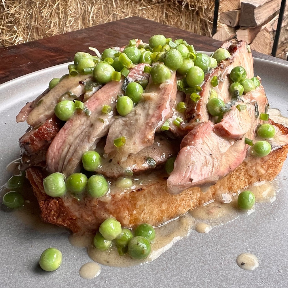 open-faced smoked turkey sandwich with gravy with peas
