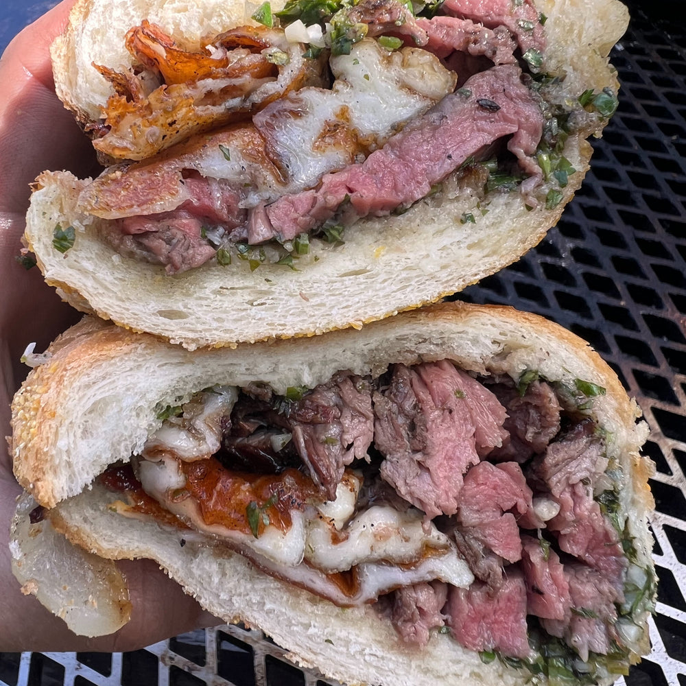 smoked chimichurri cheesesteak sandwich with grilled provolone and onions