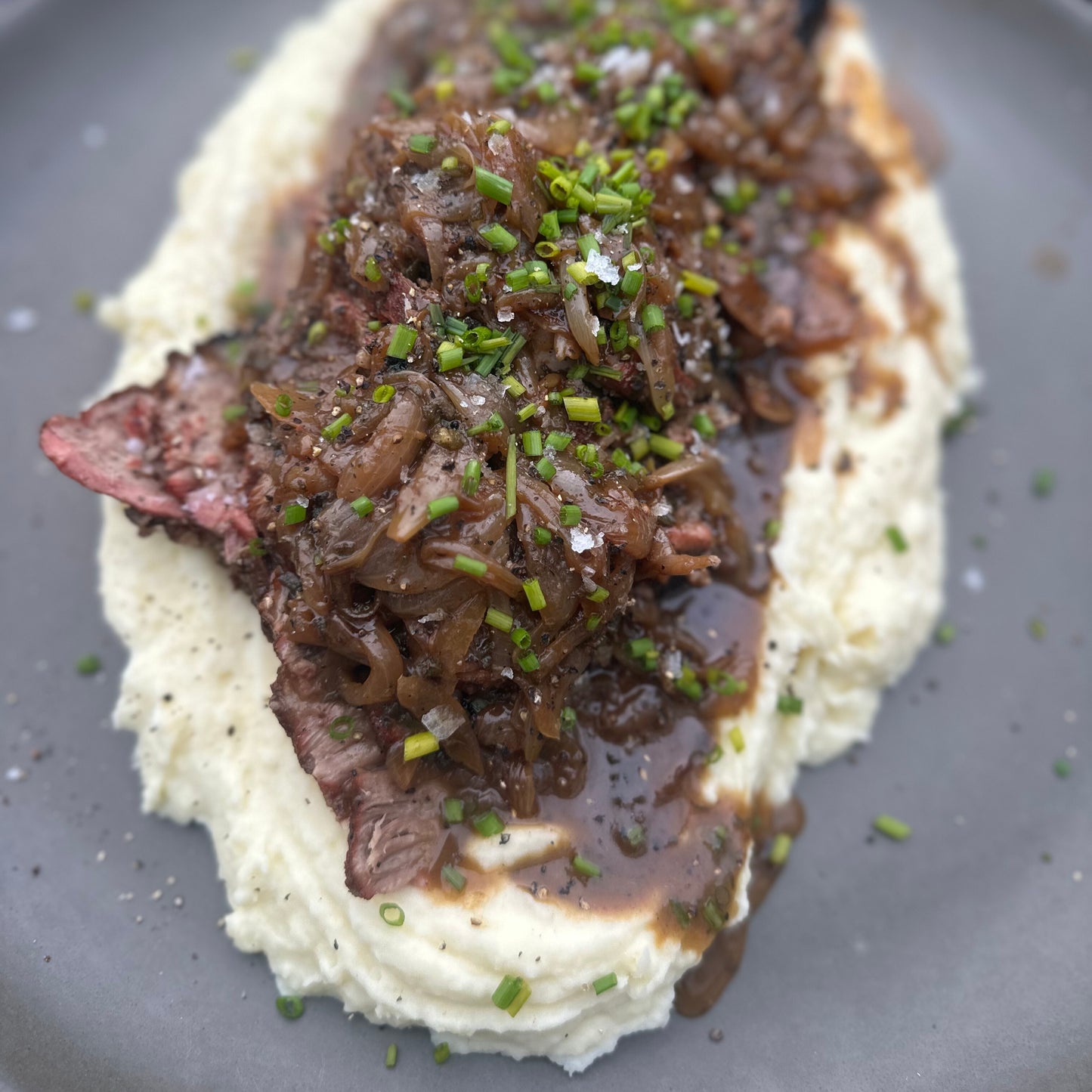 smoked smothered pork roast with onion gravy and mashed potatoes