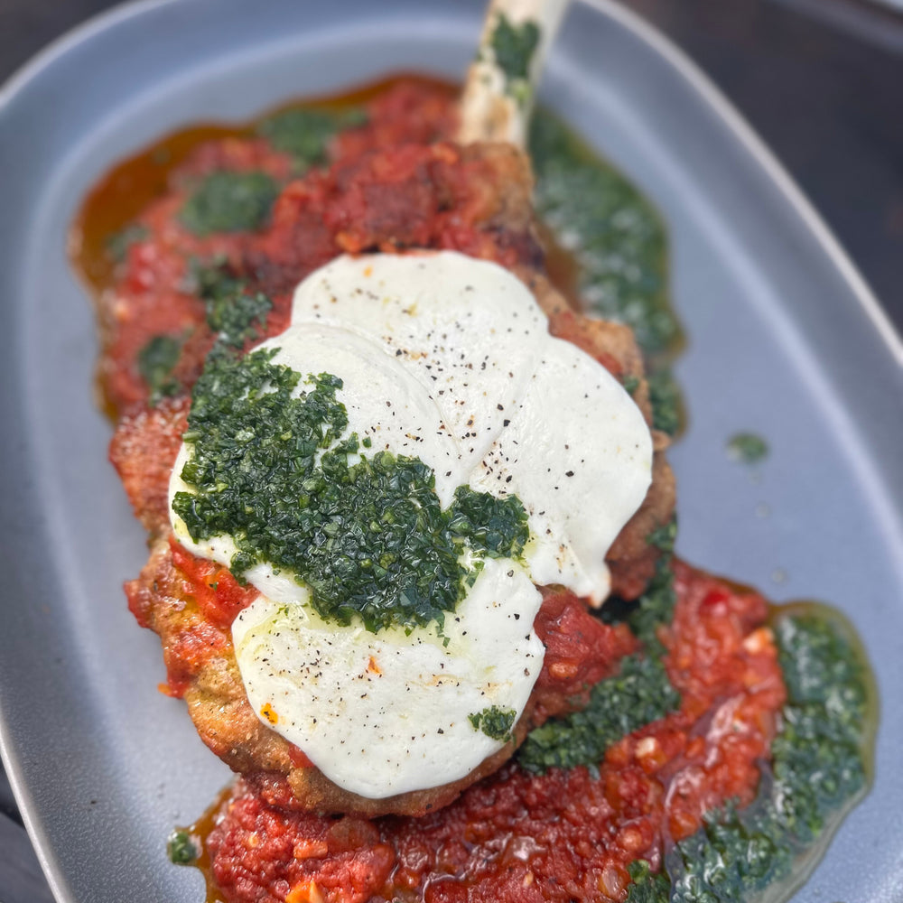 bread and fried veal chop with Sunday sauce and fresh mozzarella