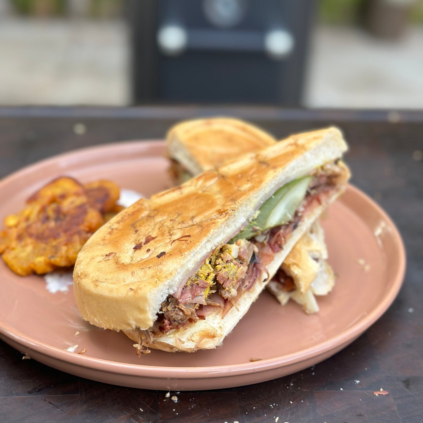 a Cubano sandwich with homemade tostones and crema